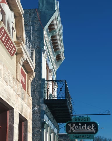Historic Fredericksburg Main Street with stone buildings and the Keidel Pharmacy sign
