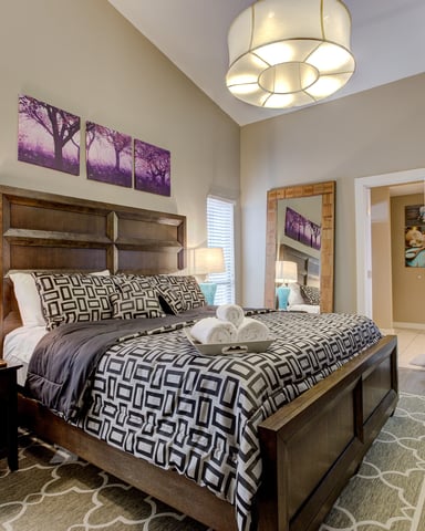 Tower Point king bedroom with neutral linens and natural light