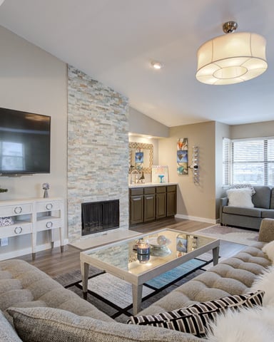 Tower Point living room with stone fireplace and leather sofa